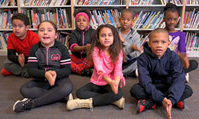 A group of children sitting in a library