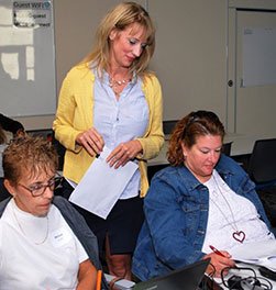 Three woman looking at paperwork