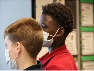 Two young boys with masks on