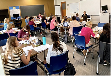 A classroom of kids sitting at desks.