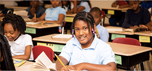 A pre-teen sitting at a classroom