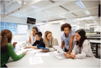 A group of colleagues collaborating around a table, smiling